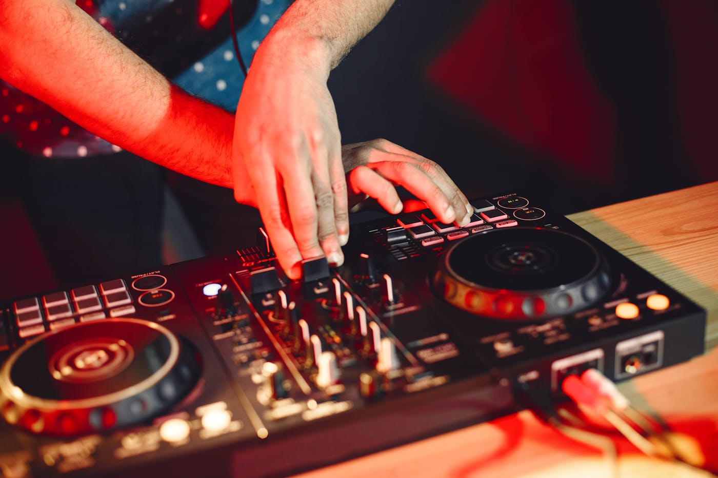DJs working behind a lit booth